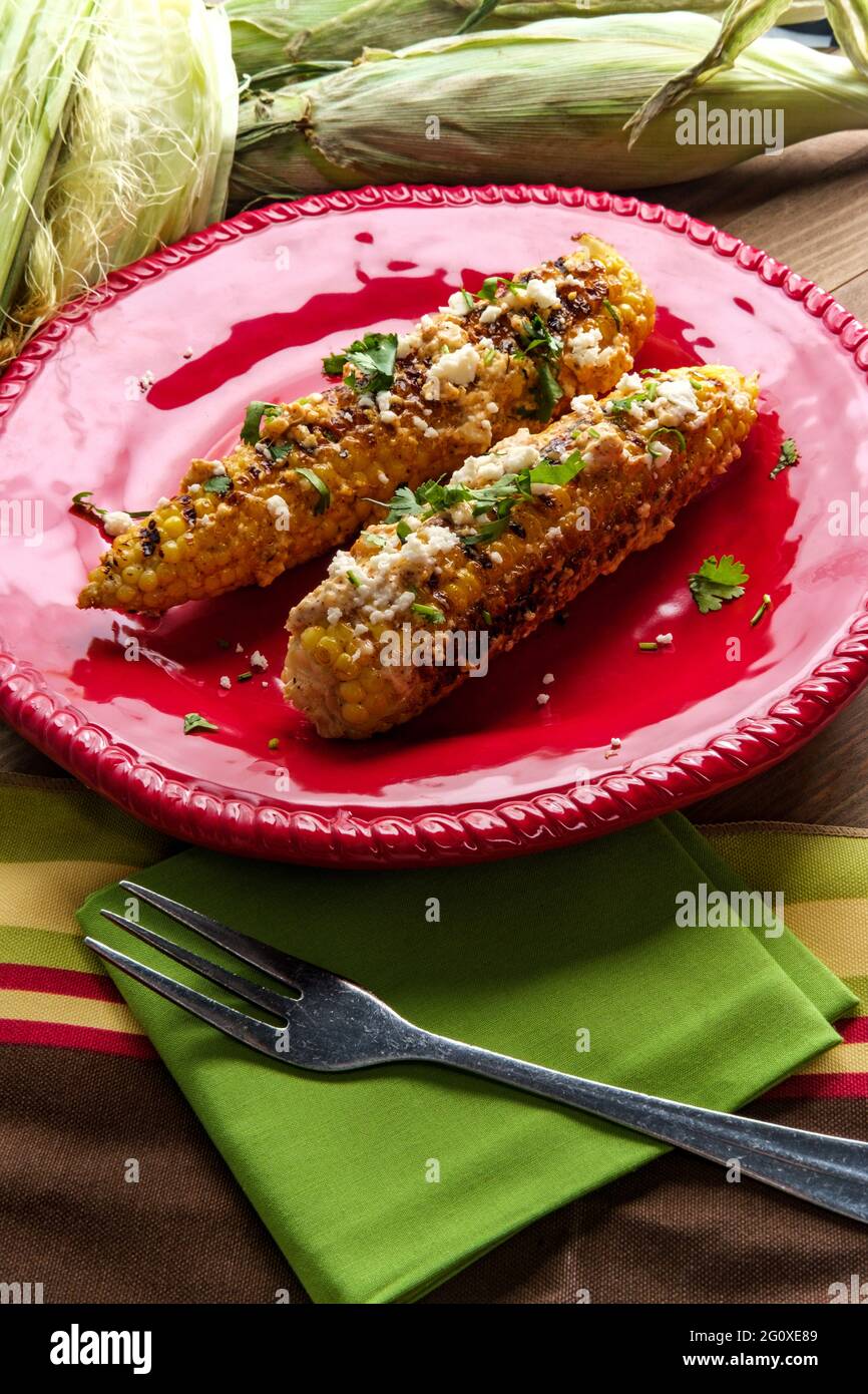 Mexican street corn also known as elote served with chili mayonnaise and cotija cheese Stock