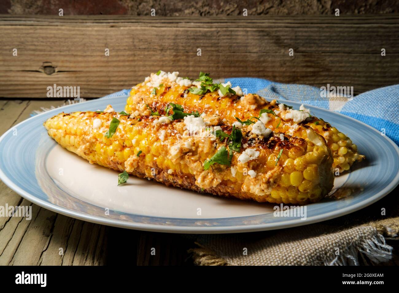 Mexican street corn also known as elote served with chili mayonnaise and cotija cheese Stock