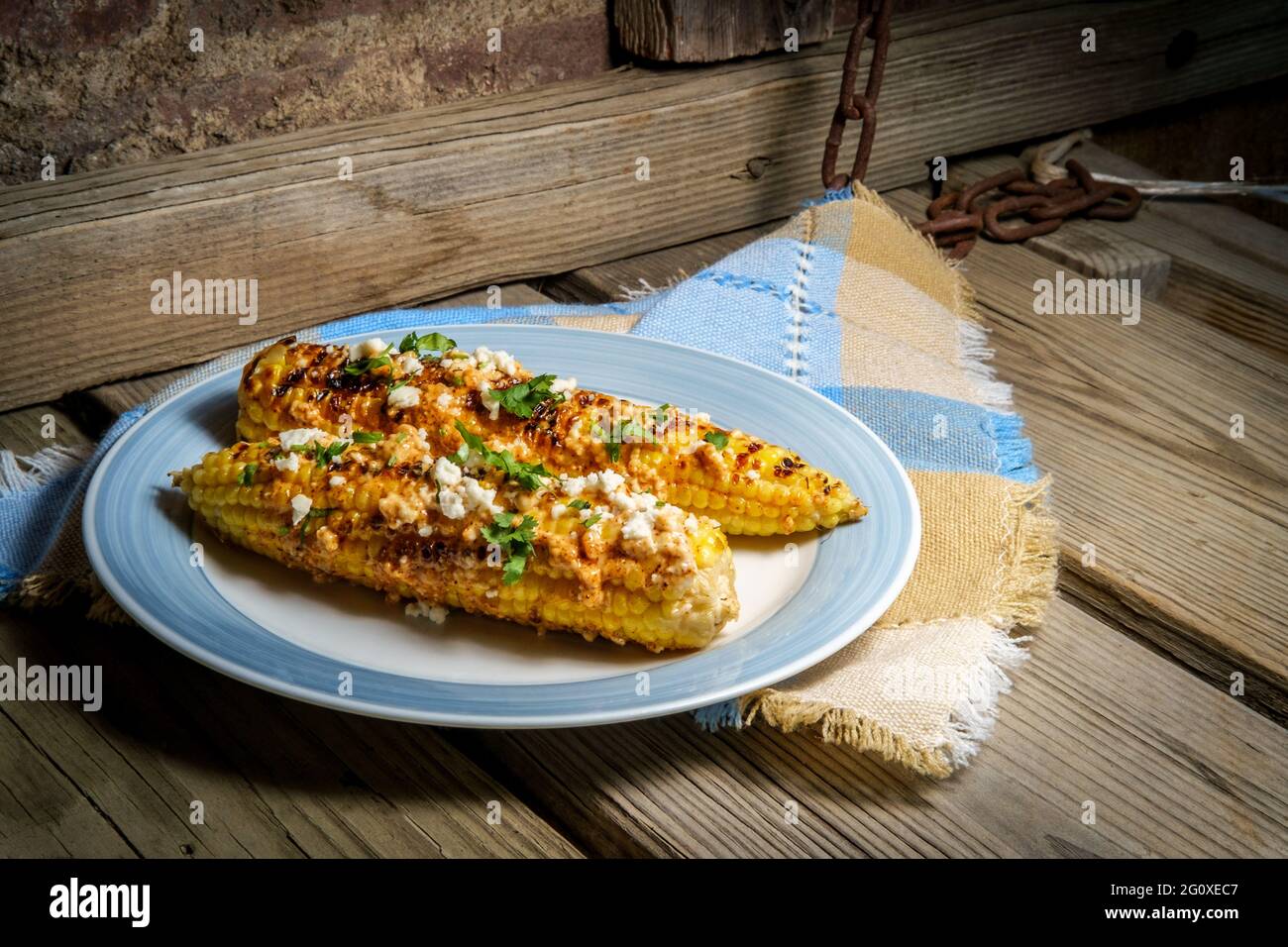 Mexican street corn also known as elote served with chili mayonnaise and cotija cheese Stock