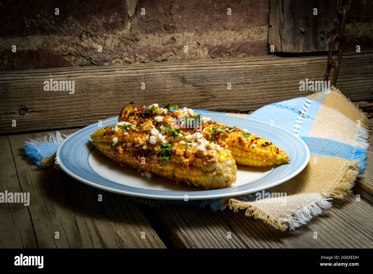 Mexican street corn also known as elote served with chili mayonnaise and cotija cheese Stock