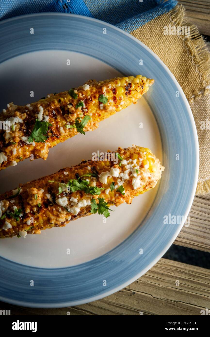 Mexican street corn also known as elote served with chili mayonnaise and cotija cheese Stock