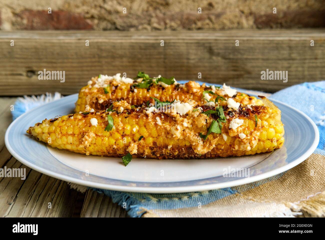 Mexican street corn also known as elote served with chili mayonnaise and cotija cheese Stock