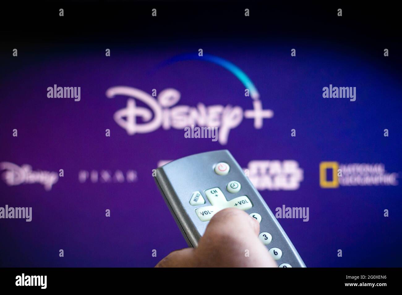 In this photo illustration a person holding a TV remote control and the ...