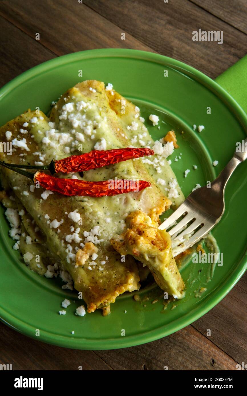Mexican enchiladas with creamy poblano pepper sauce and queso fresco