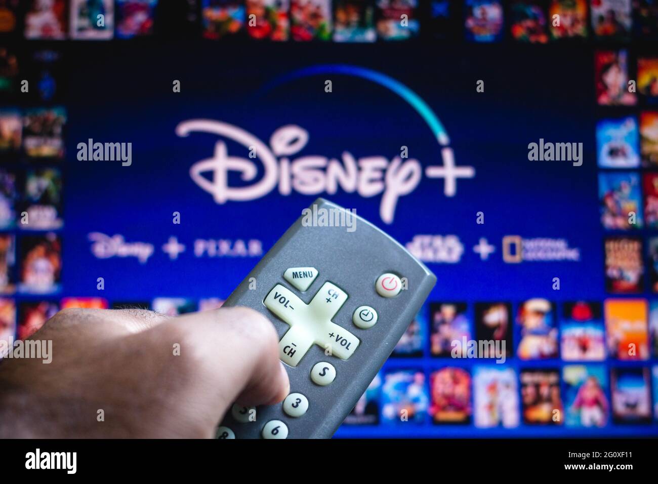 In this photo illustration a person holding a TV remote control and the ...