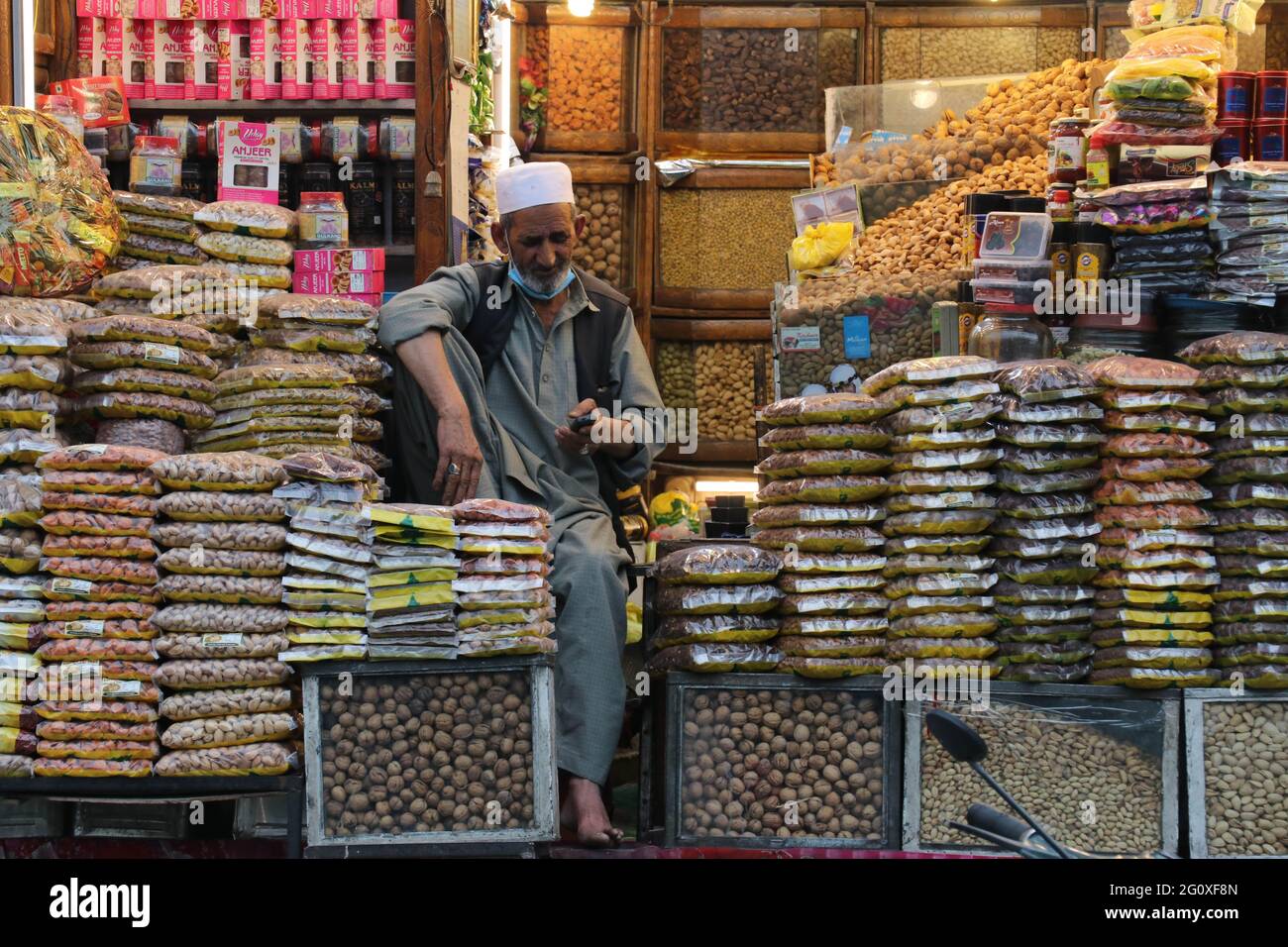India. 03rd June, 2021. A shopkeeper uses his mobile phone while waits