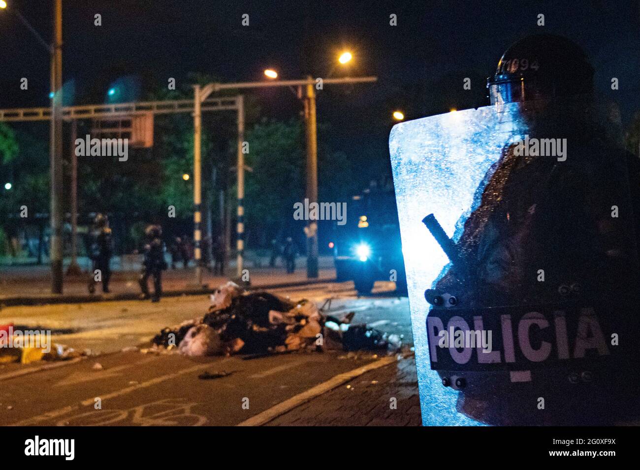 June 2, 2021, Medellin, Antioquia, Colombia: A colombia's riot police officer (ESMAD) is backlit by a riot armored tuck during clashes with demonstrators as anti-government protests rise into a 5th week against the government of president Ivan Duque's health and tax reform, and police abuse of authority cases in Medellin, Colombia on June 2, 2021. (Credit Image: © Miyer Juana/LongVisual via ZUMA Wire) Stock Photo
