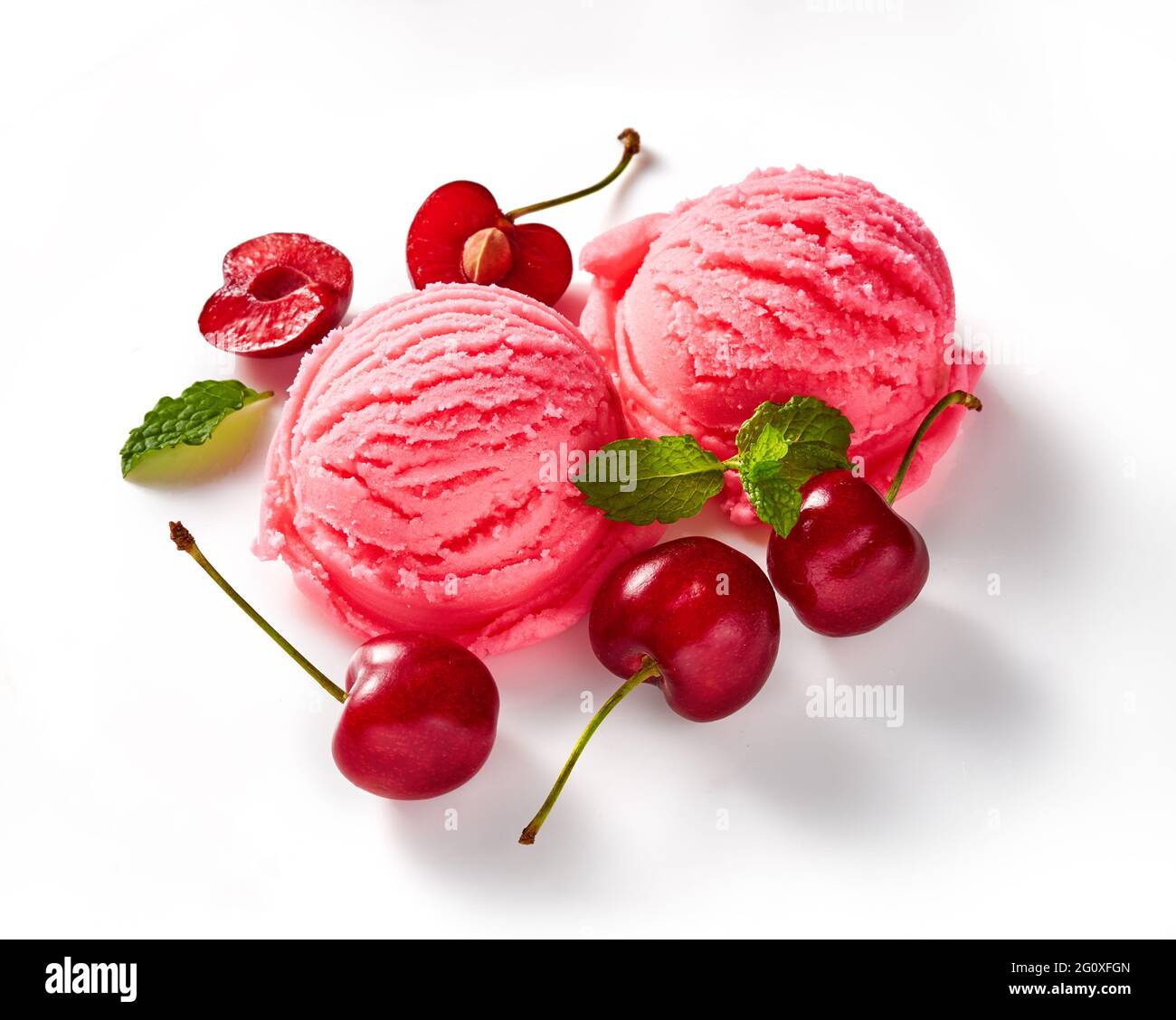 Cherry ice cream with cherry berries on white background. Ice cream with cherry sauce isolated for package of ice cream. Stock Photo