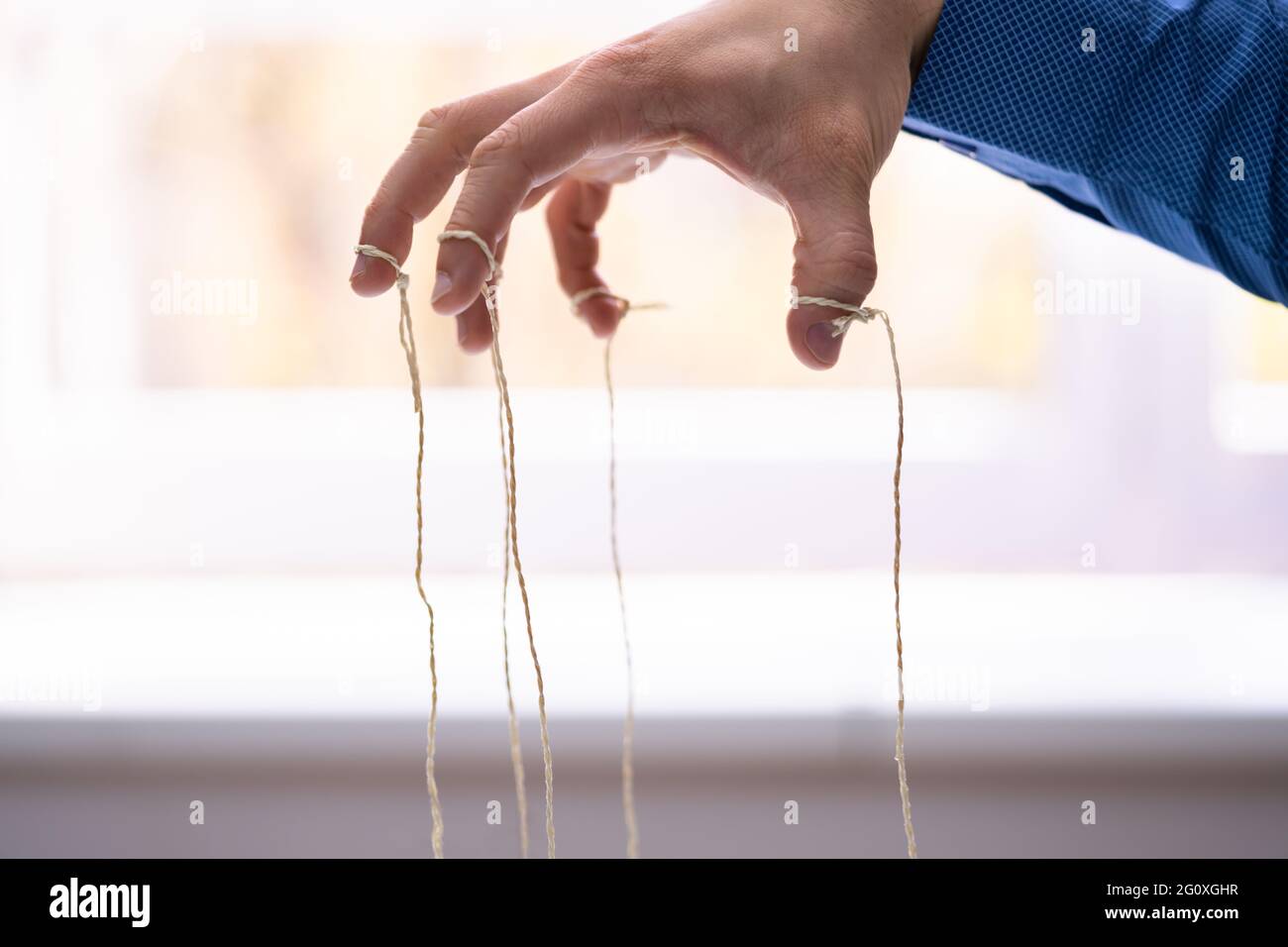 Manipulating Marionette Puppet Strings By Hand. Business Power Stock Photo