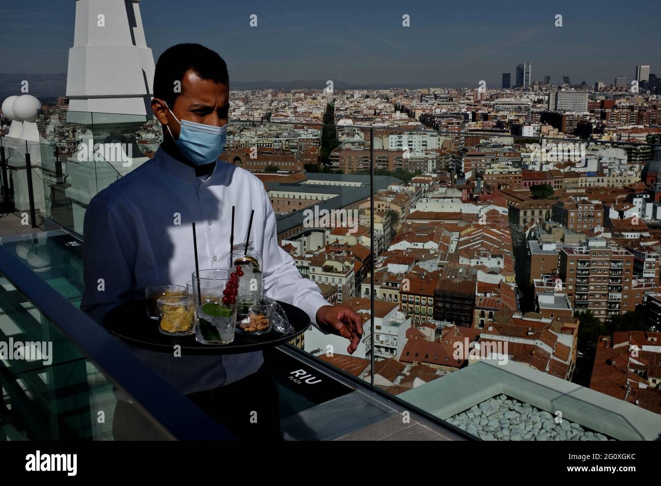 A waiter at the terrace of the Riu Plaza de España hotel, with a panoramic view of Madrid in the background. Stock Photo