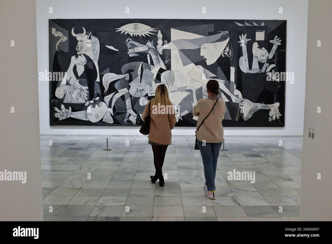Tourists watching the famous Guernica, by Pablo Picasso, at the Reina Sofia museum, in Madrid, Spain. Stock Photo