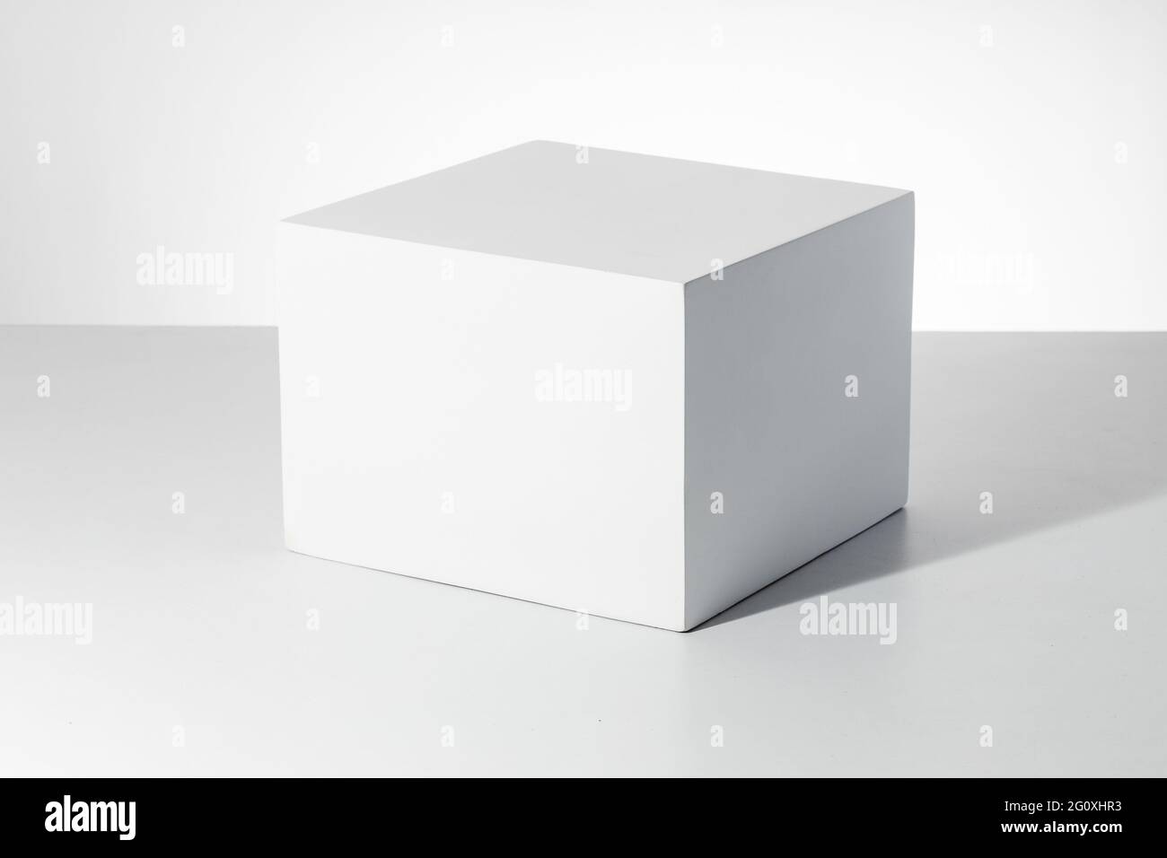 3D rendering of a white empty cube with mockup against a white ...