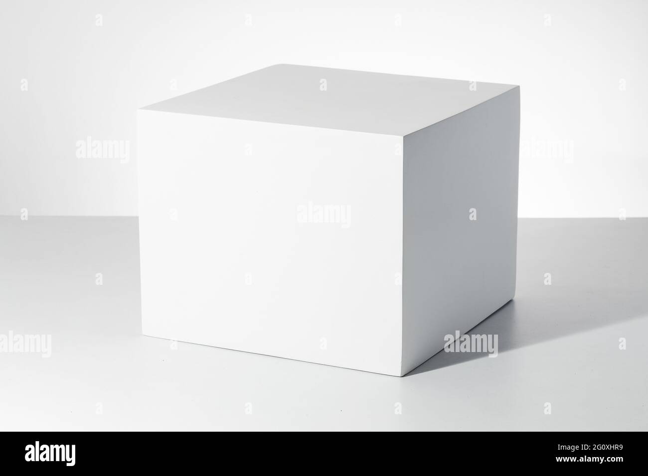 3D rendering of a white empty cube with mockup against a white ...