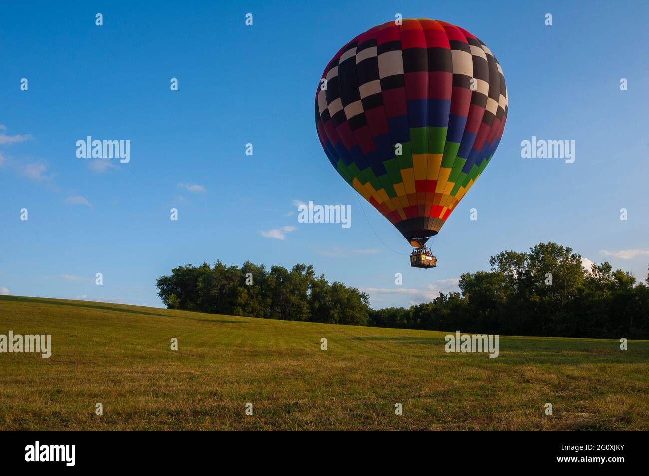 A hot air balloon floats above a a field near Indianola, Iowa, as the ...