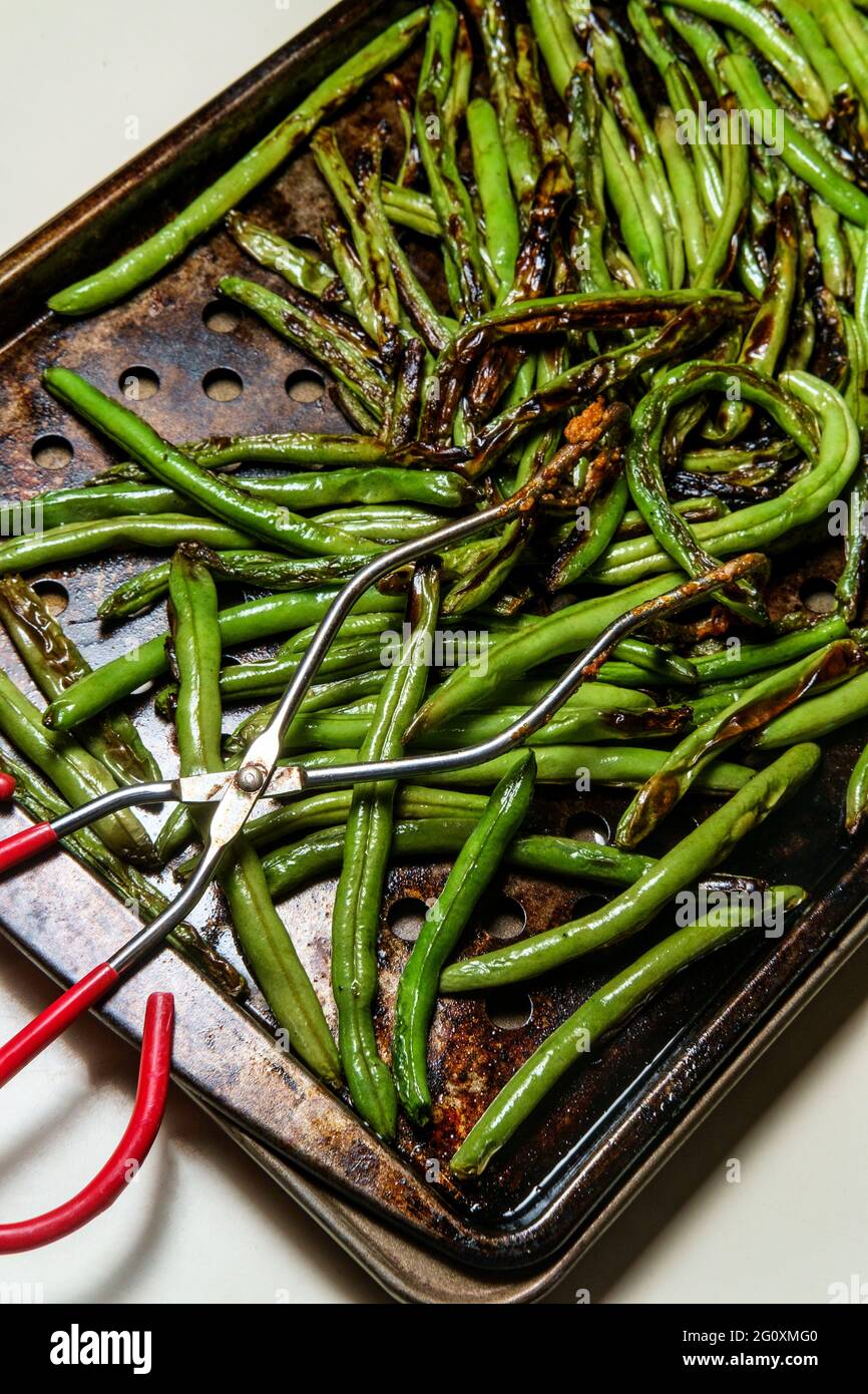 Roasted chargrilled green beans cooling in oven pan Stock Photo Alamy