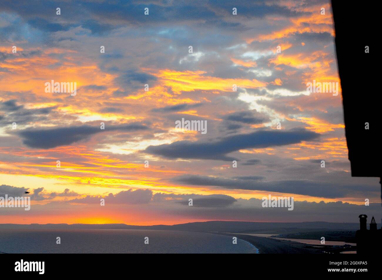 Chesil Beach. 3rd June 2021. UK Weather. Fiery sunset over Chesil Beach