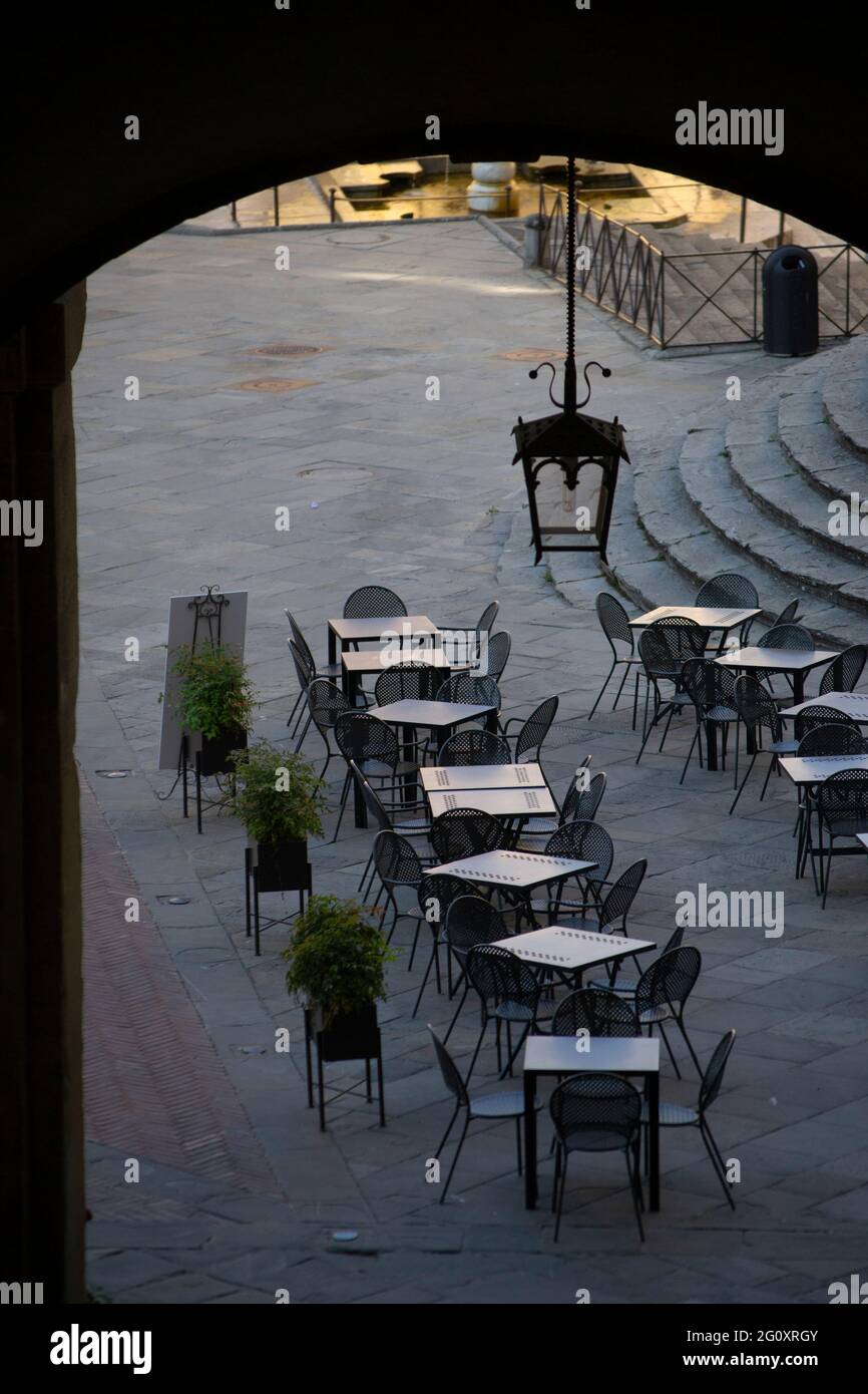 empty tables of a restaurant on the main square of the historic center, at dawn Stock Photo