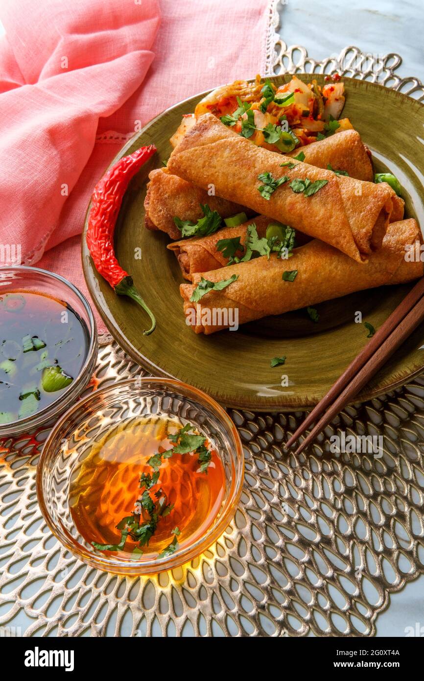 Deep fried dim sum Chinese kimchi spring rolls with dipping sauces