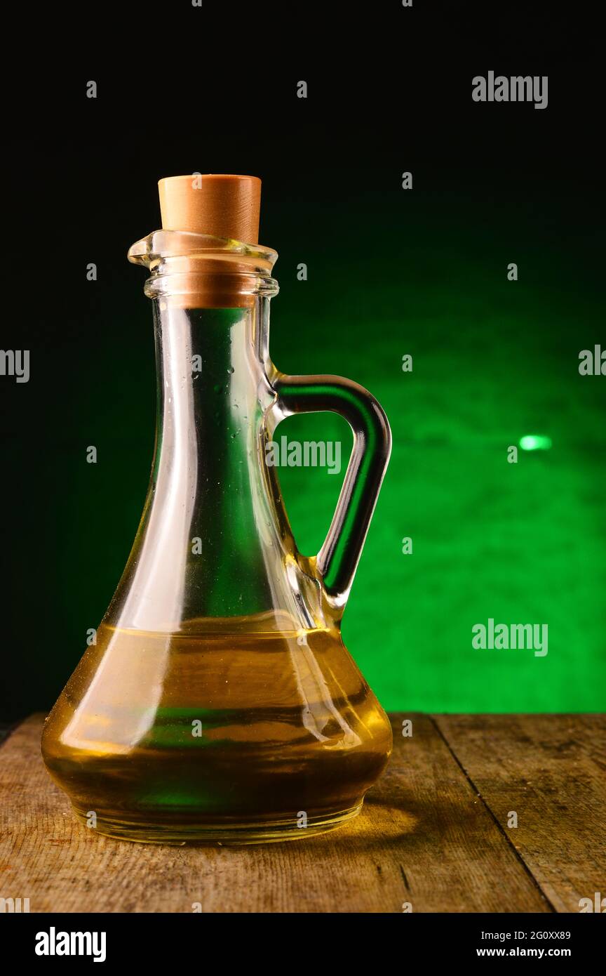 Bottle of extra virgin olive oil ,on green background Stock Photo - Alamy