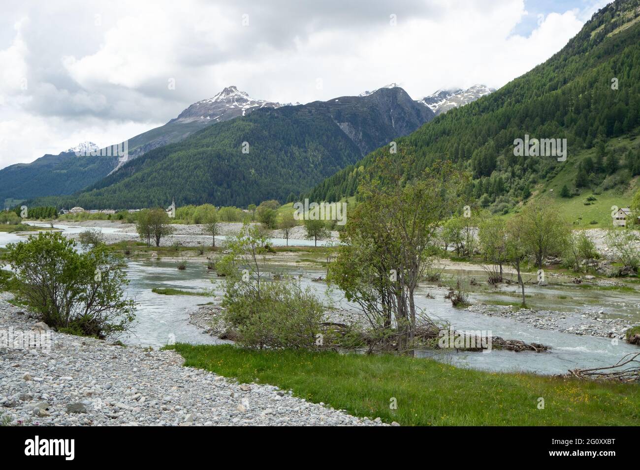 View over a wild Inn river landscape in Engadin, Switzerland, with mountains Stock Photo