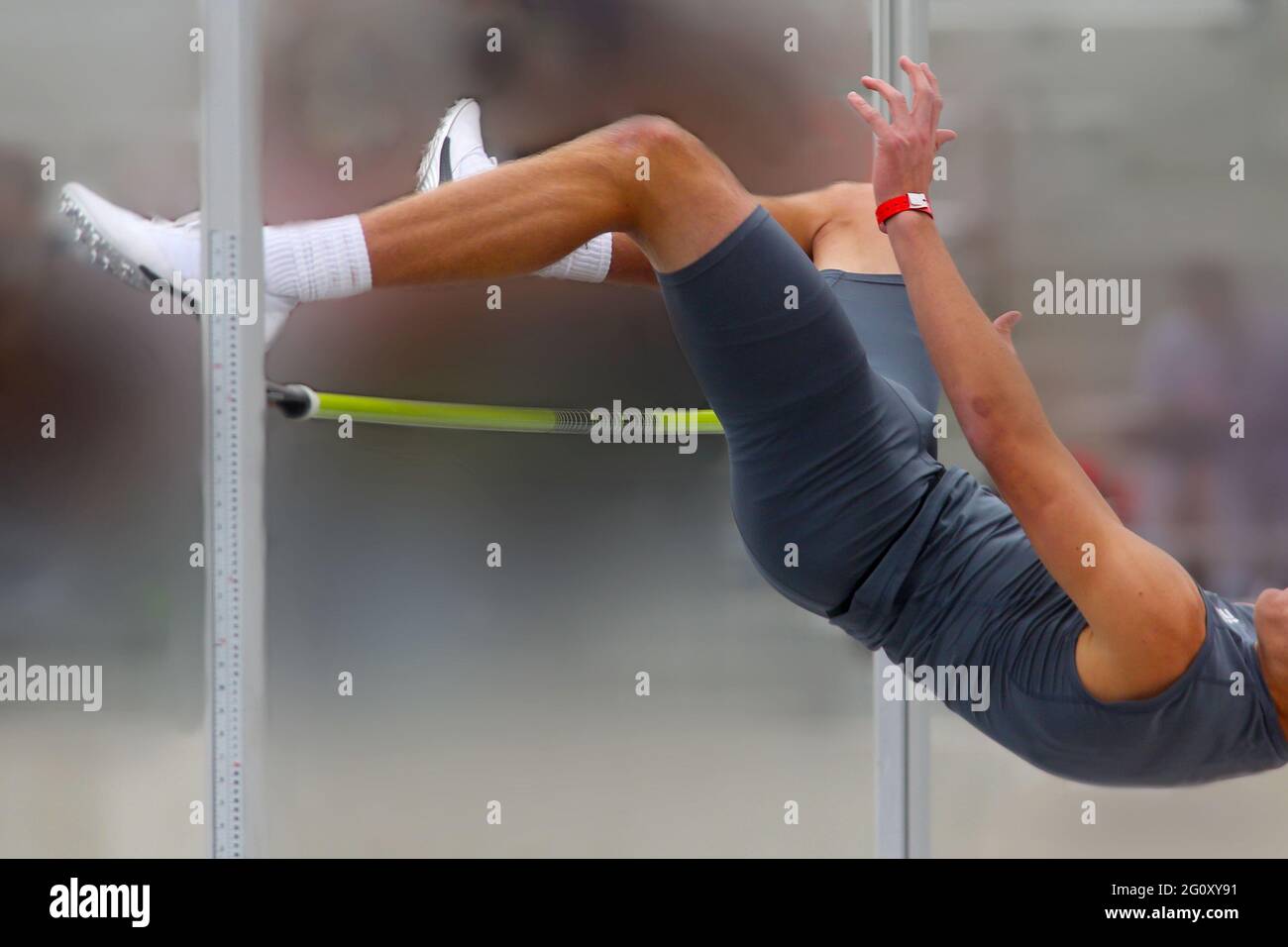 A high jumper clears the bar during a track and field competition Stock