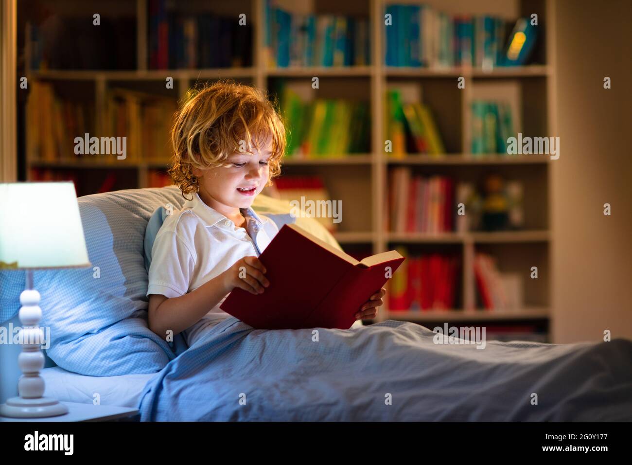 Child reading book in bed. Kids read at night. Little boy with fairy tale books in bedroom Education for young children. Bedtime story in the evenin Stock Photo Alamy