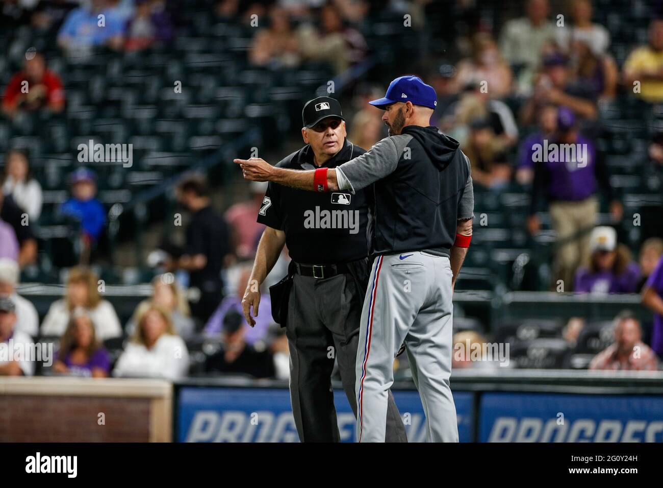 Texas Rangers manager Chris Woodward argus with home plate umpire Larry Vanover during an MLB regular season game against the Colorado Rockies, Wednes Stock Photo