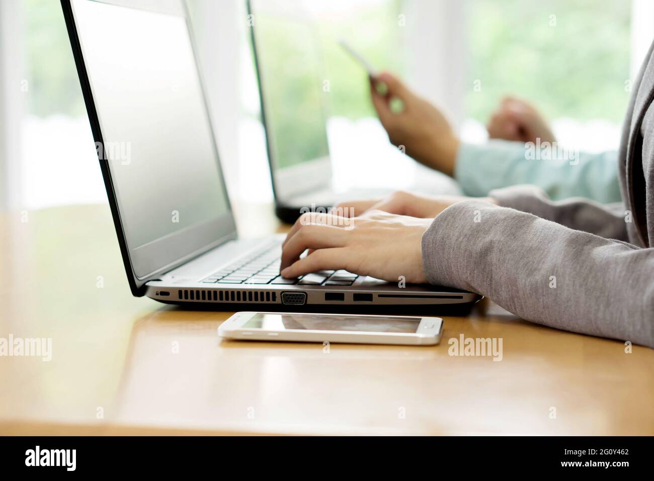 Smiling business team working on computer in office Stock Photo