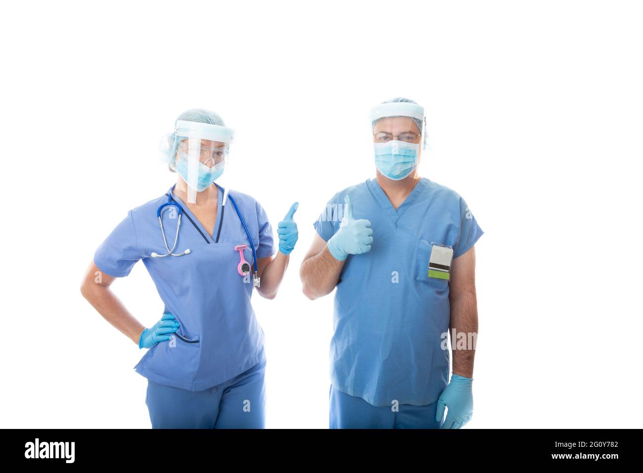 Two rapid response critical care nurses give a thumbs up hand gesture. They are wearing scrubs