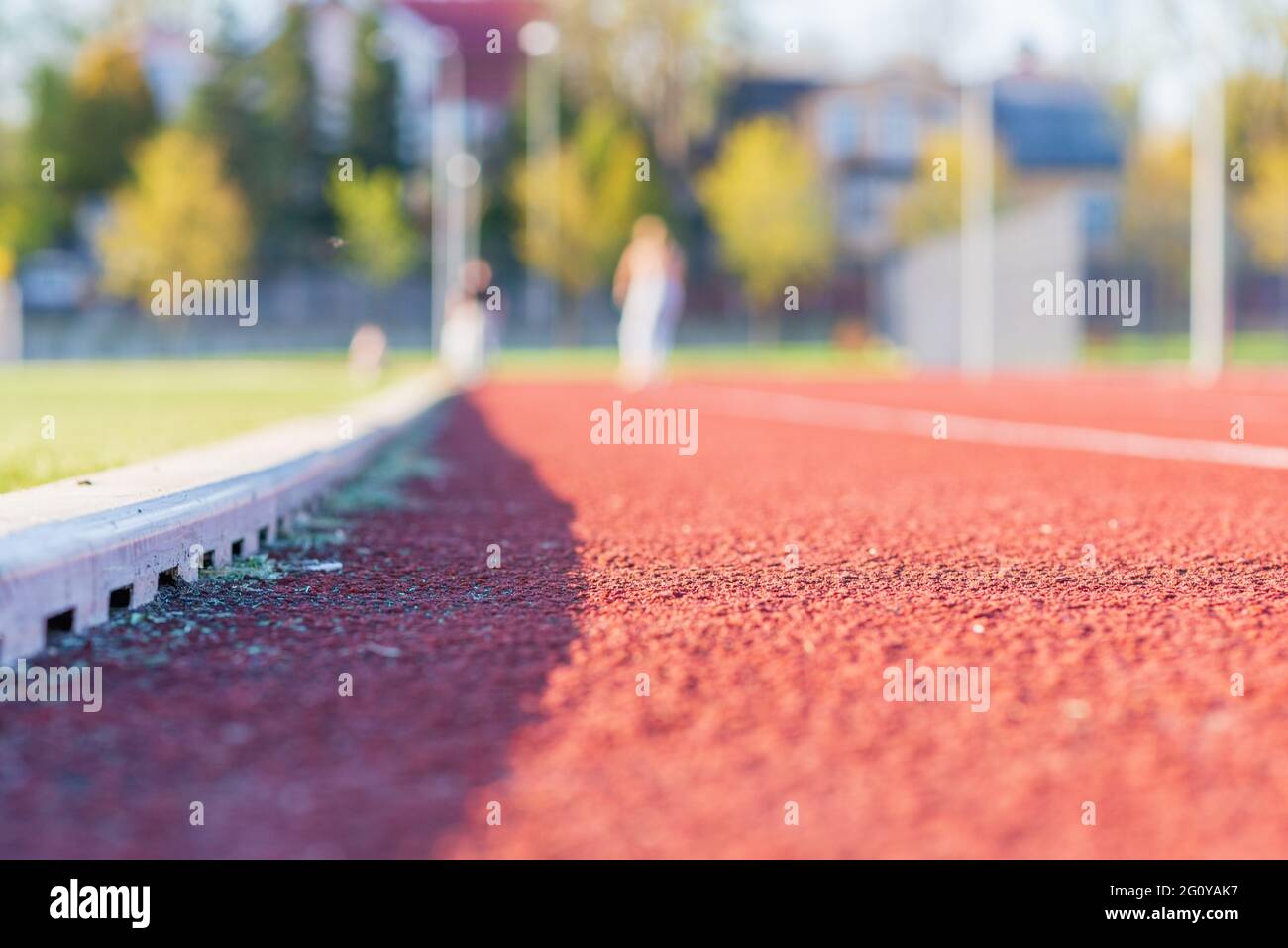 Red plastic track in the outdoor track and field stadium.Closeup. Stock Photo