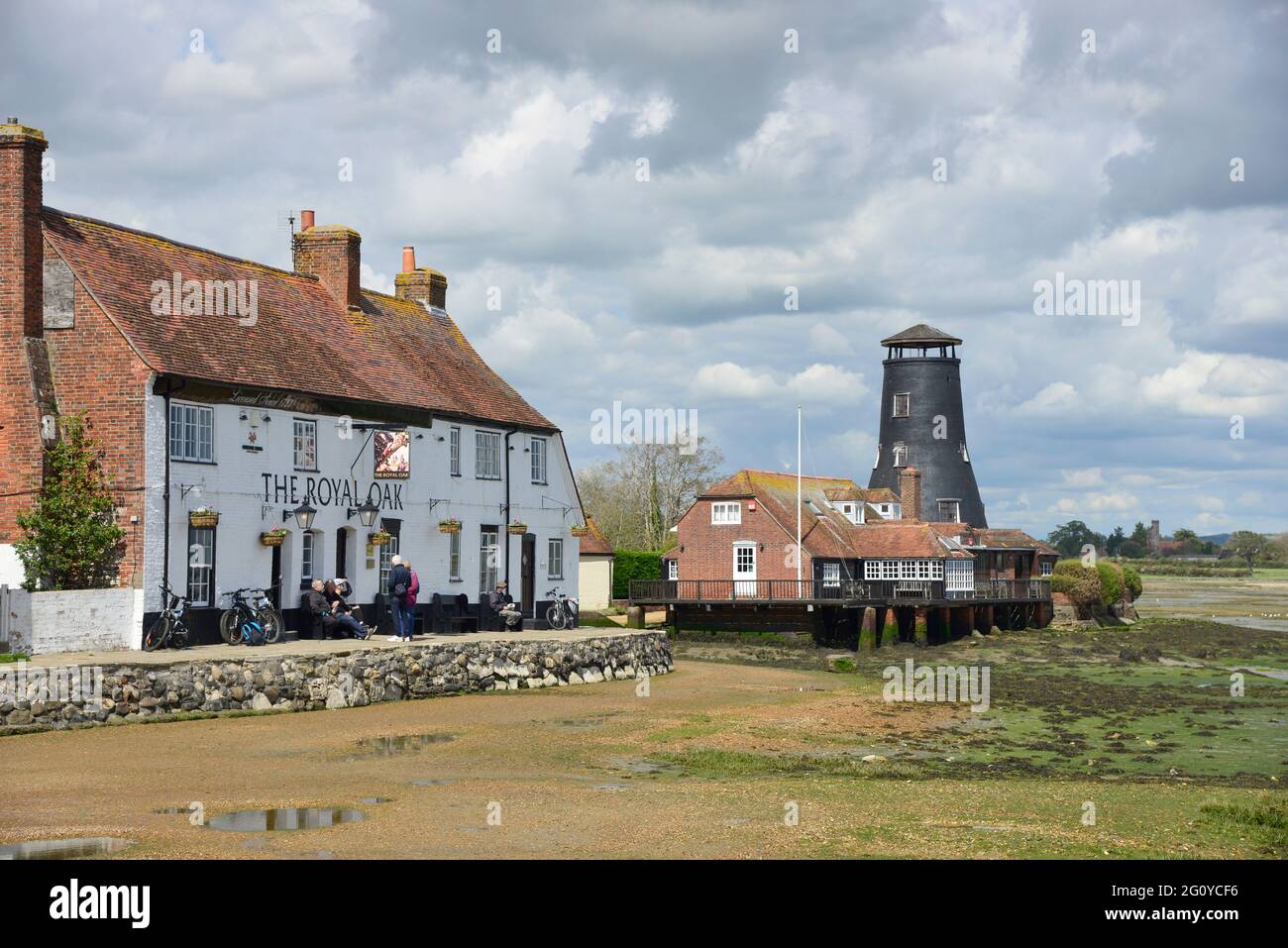 The Royal Oak Public House and Langstone Mill on the edge of Langstone Harbour, Havant, Hampshire, England, UK Stock Photo