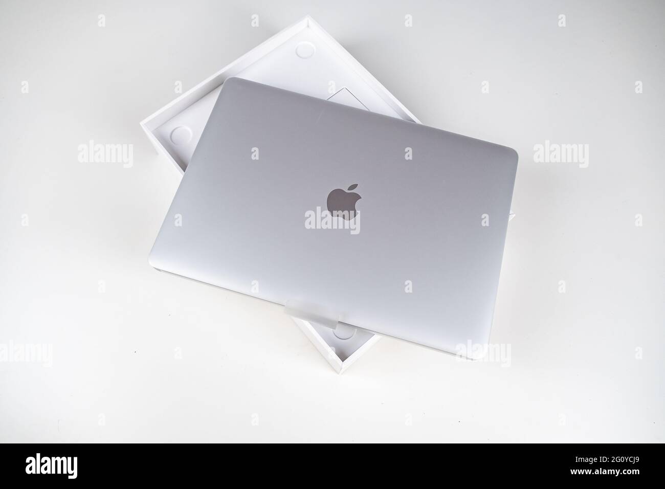Unboxing a silver macbook air on a white table. Apple laptop Stock Photo