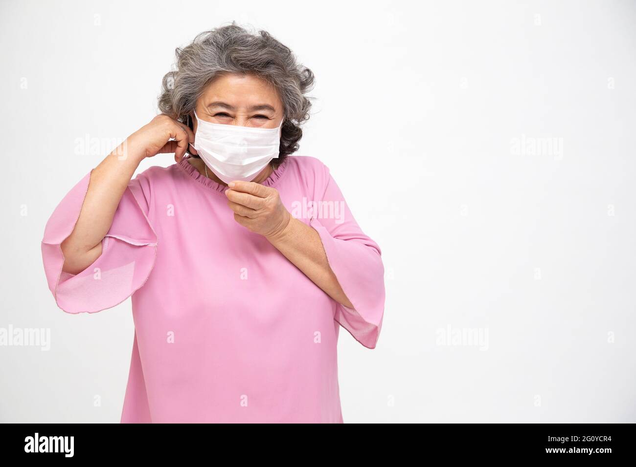 Asian senior woman wearing a protective face mask for plague coronavirus or covid-19 infectious disease. Facial hygienic mask for safety outdoor envir Stock Photo
