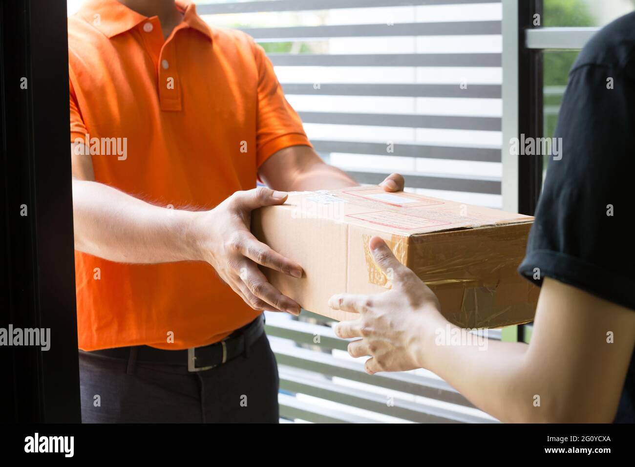 Woman hand accepting a delivery of boxes from deliveryman Stock Photo