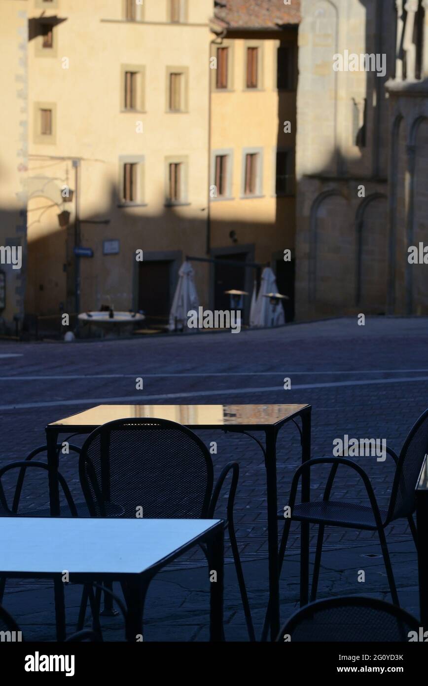 empty tables of a restaurant on the main square of the historic center, at dawn Stock Photo
