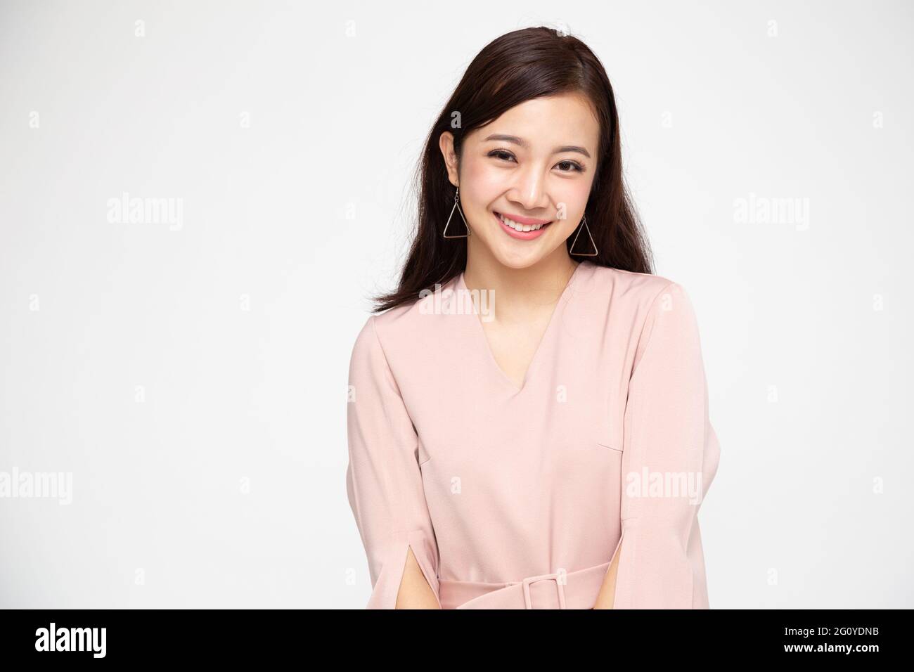 Portrait of young business woman smiling and looking at camera isolated ...