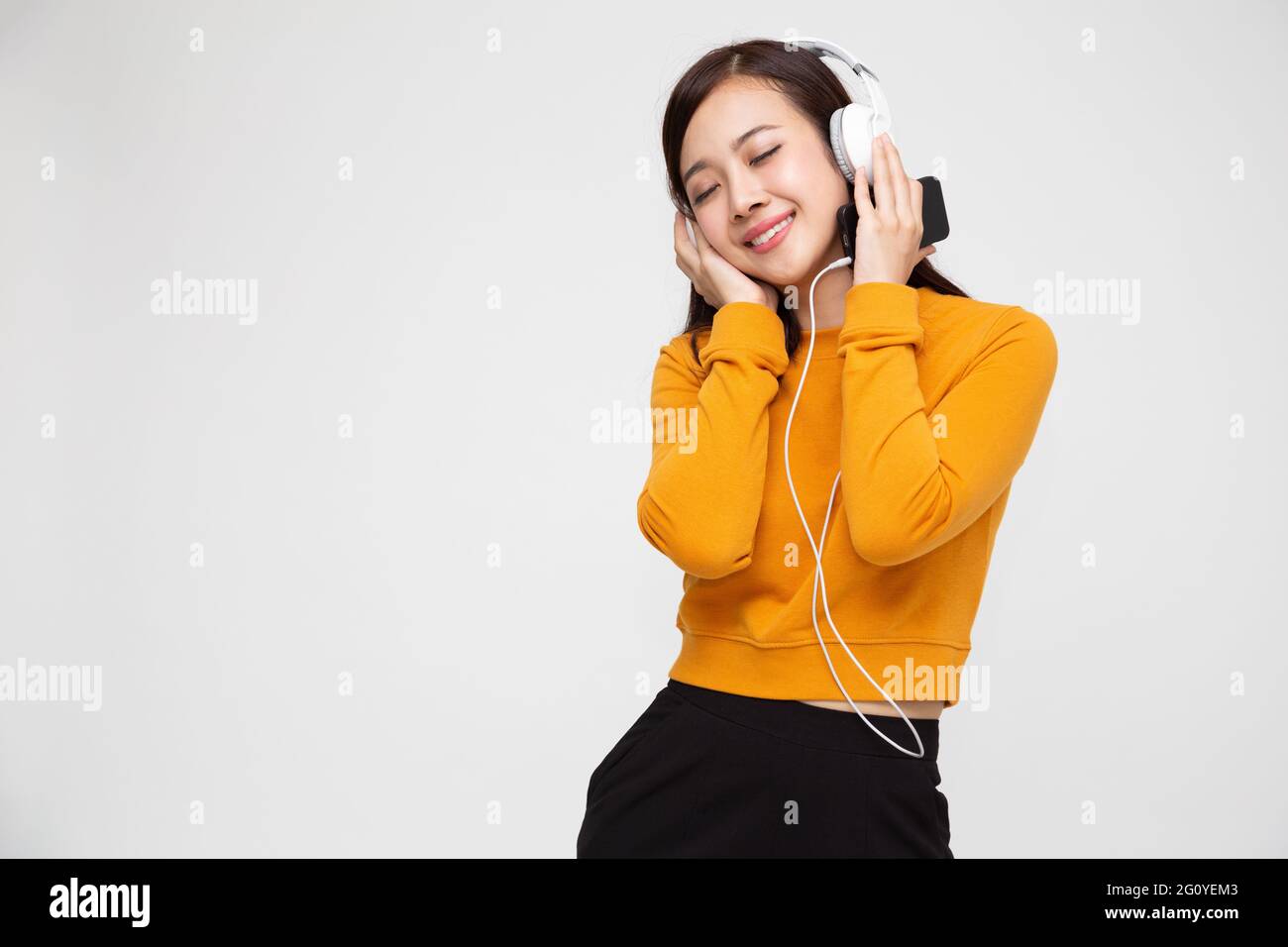 Young Asian beauty woman listening music with headphones in playlist ...