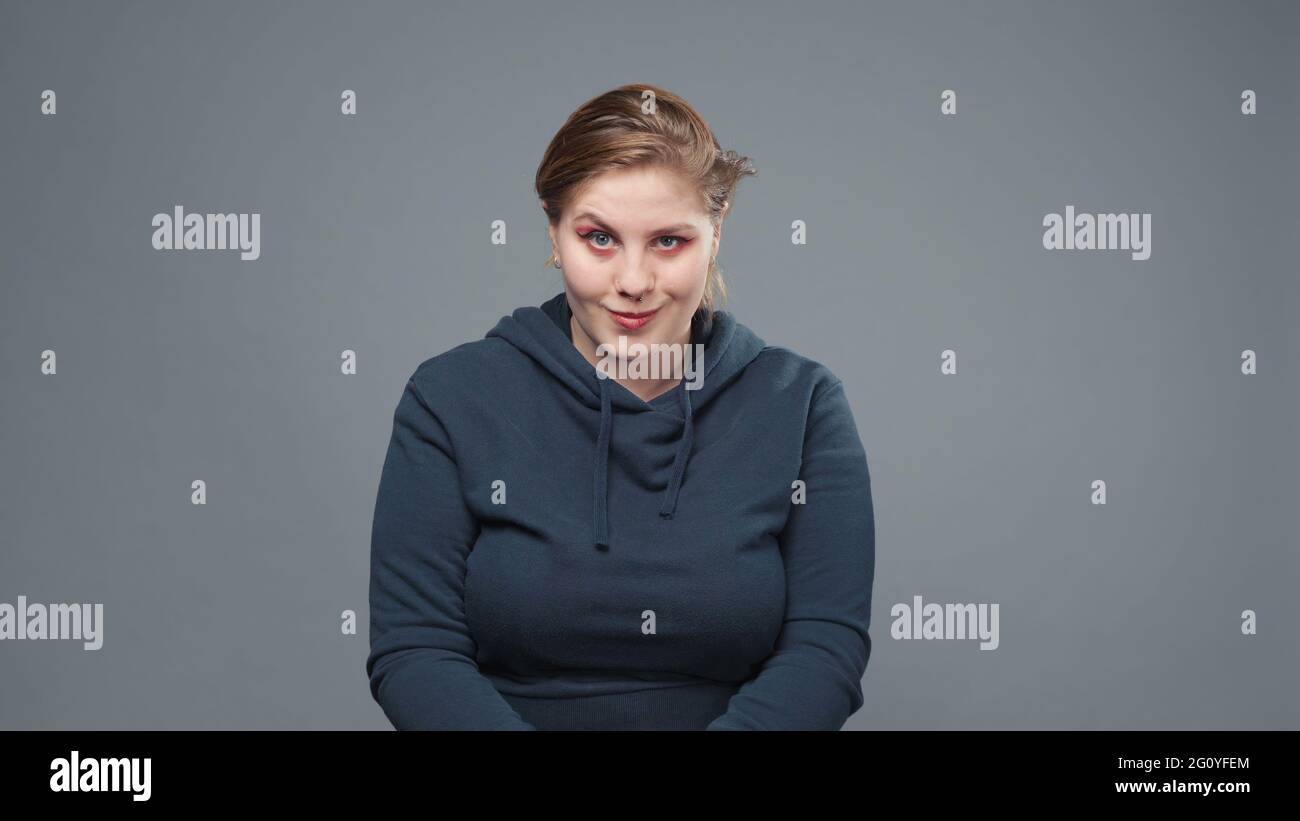 Photo of flirting stout woman in sweatshirt Stock Photo