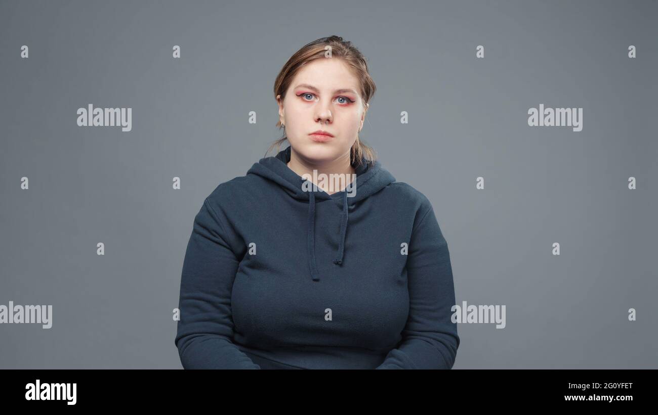 Photo of serious stout woman in sweatshirt Stock Photo