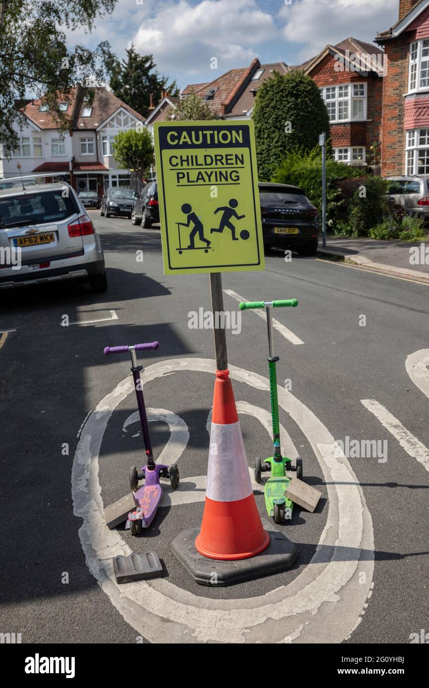 CAUTION Children playing sign positioned to slow traffic down at the entrance to residential cul-de-sac, England, United Kingdom Stock Photo
