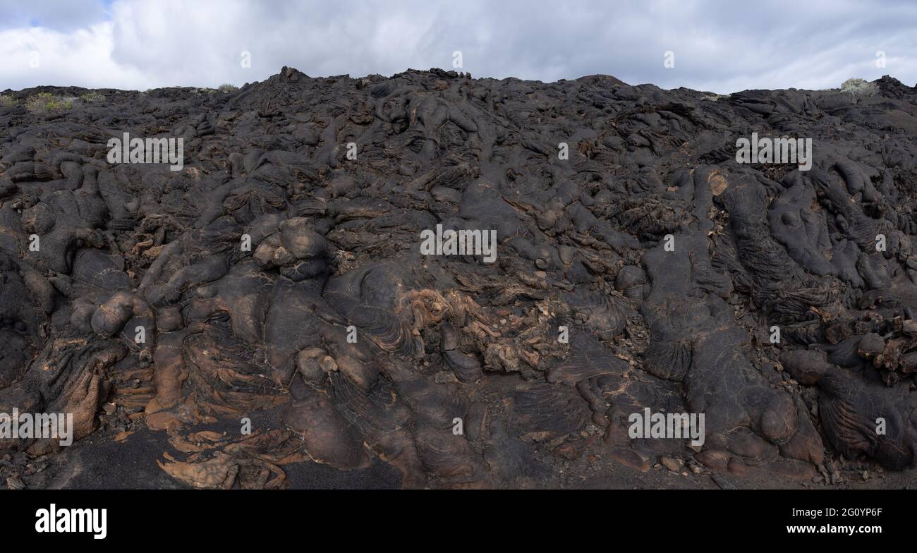 Area of solidified black lava - pahoehoe lava Stock Photo