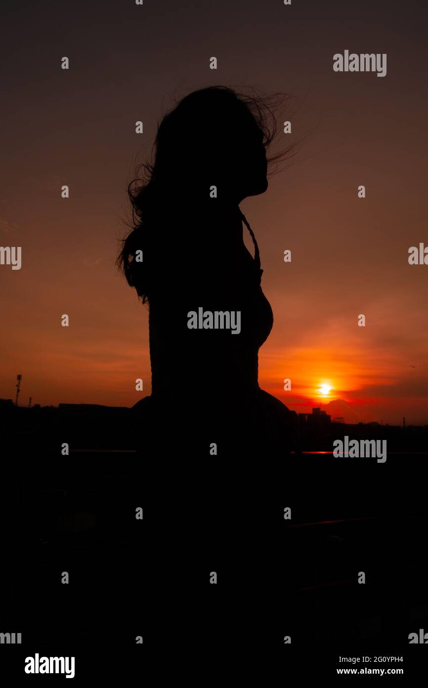 Photo of silhouette adult woman in profile on twilight background