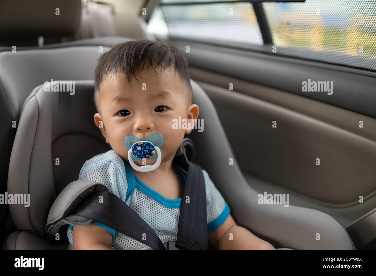 Local lifestyle Asian Chinese baby boy with emotion face and sucking