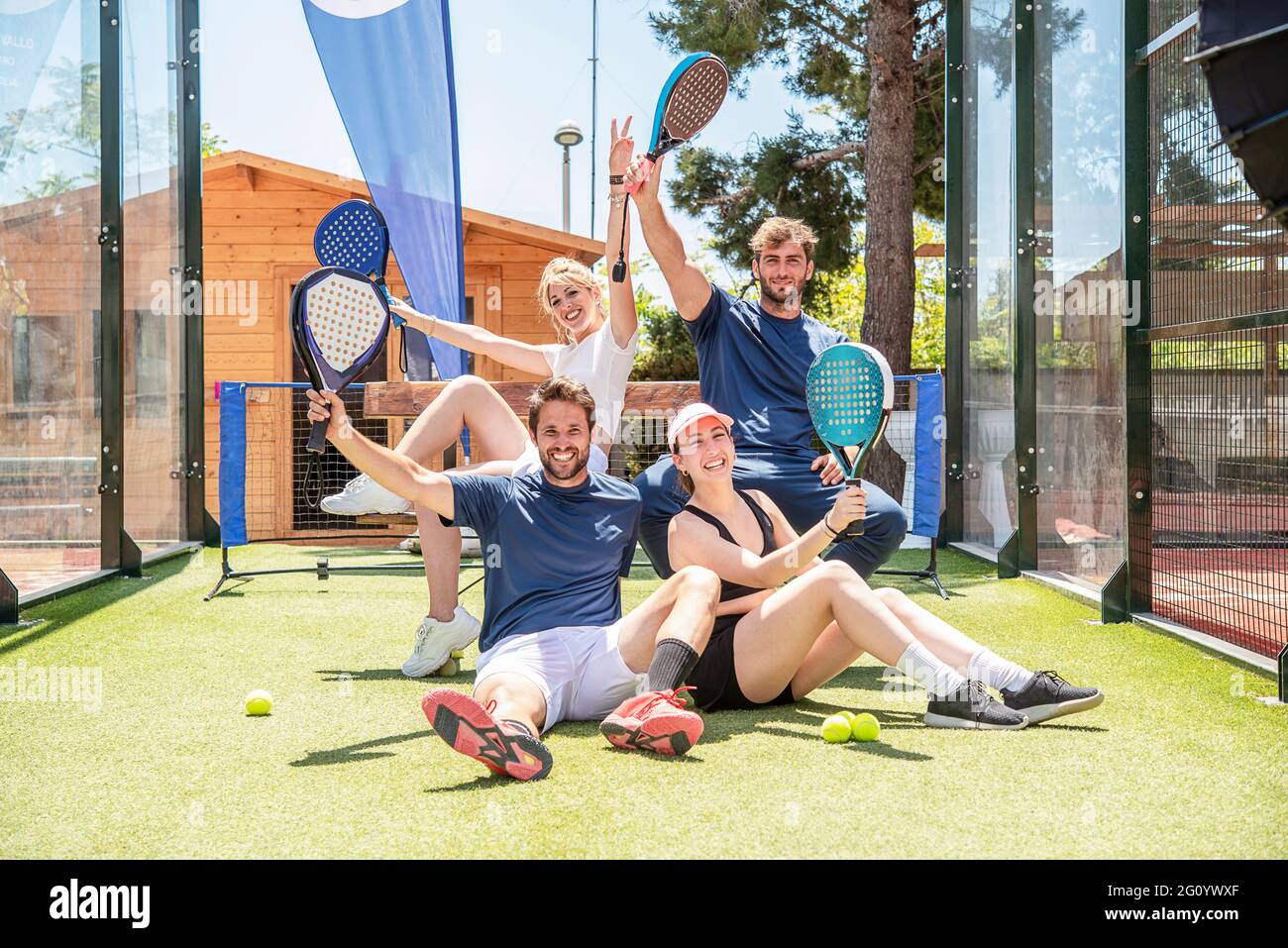 four happy winning padel tennis players celebrate after winning the match Stock Photo