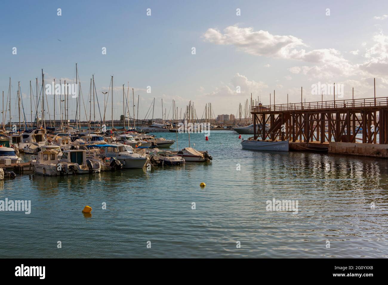 05-10-2021. Torrevieja, Alicante, Spain. Boats moored by the nautical club that manages 570 moorings in the Marina. All moorings have drinking water a Stock Photo