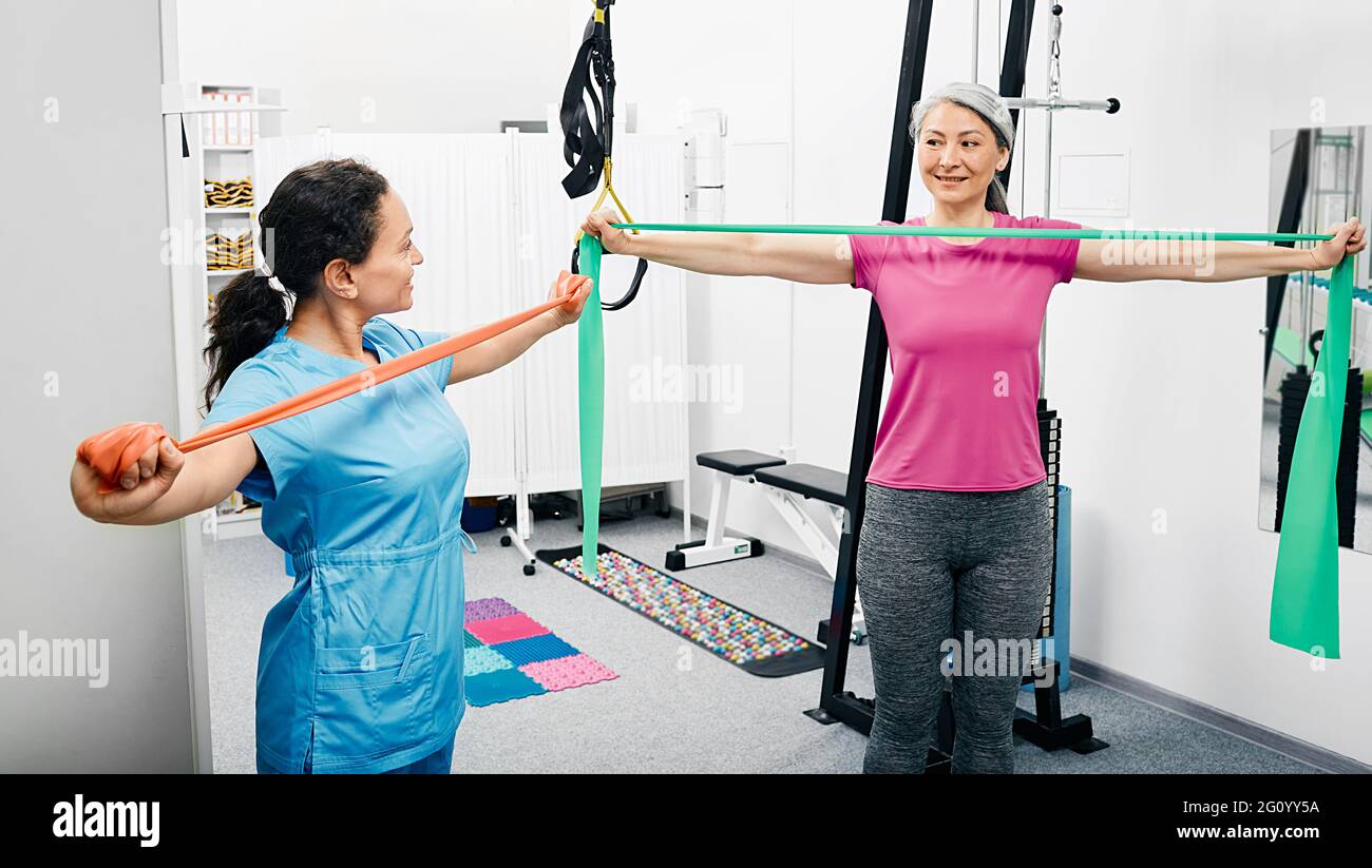 Rehabilitation therapist shows correct execution of exercise with a