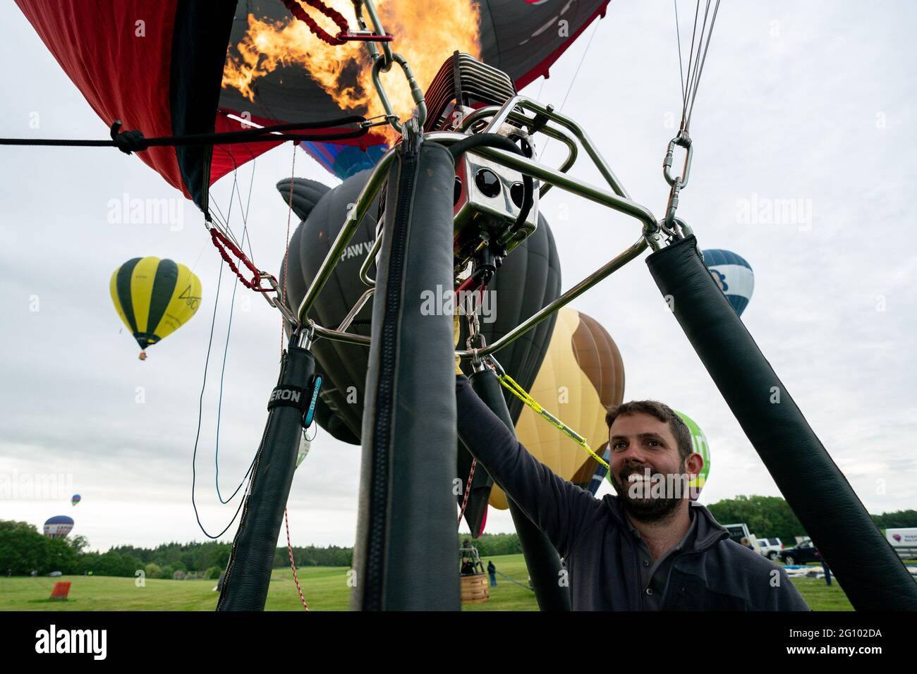 Balloonists prepare to take flight during the opening of the Midlands Air Festival in Alcester, Warwickshire. Picture date: Friday June 4, 2021. Stock Photo