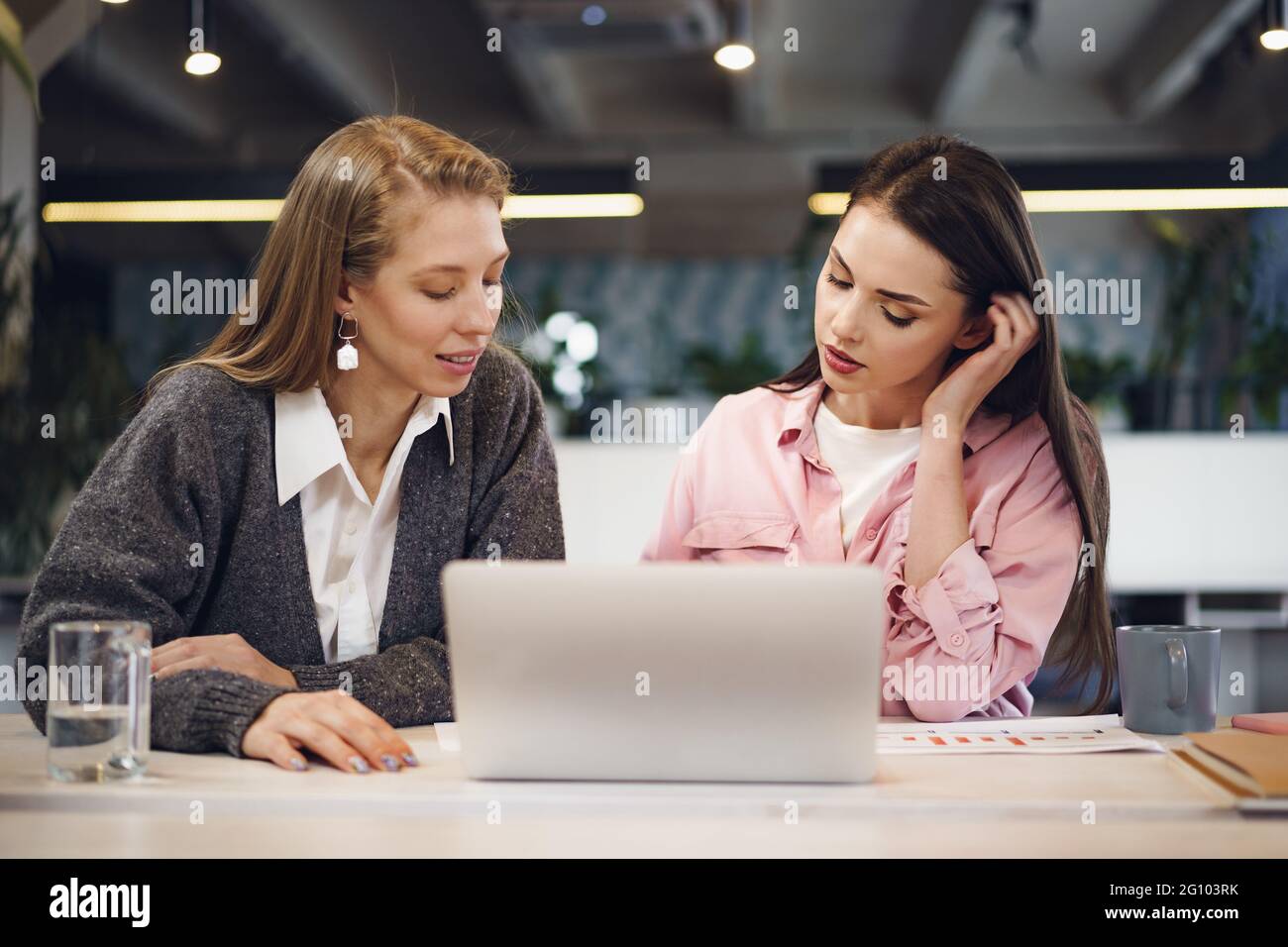 Two young women working together in office Stock Photo - Alamy