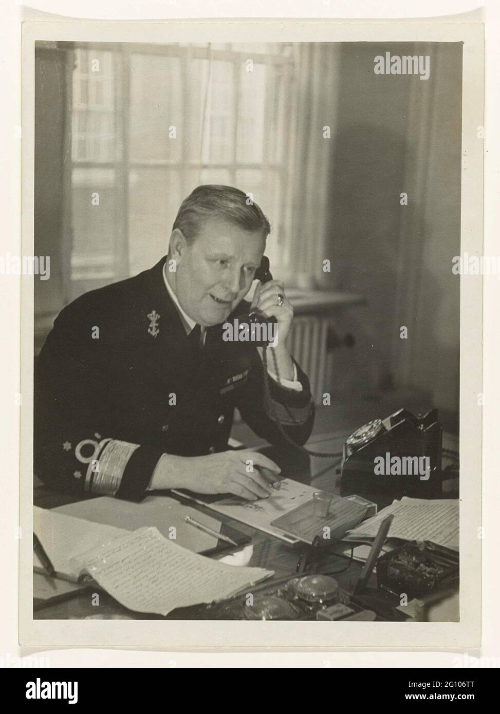 Portrait of a telephone minister J.Th. Furstner, Marine Minister during the Second World War. During the Second World War, the staff of the Dutch Marine was located in London led by Admiraal Furstner (1887-1970). On May 14, 1940, vice-admiral Johannes Theodorus Furstner left from the Netherlands to London. On May 19th he was appointed commander of the Dutch sea and marine anchor forces who were in Allied territory. The commander was actually only involved in personnel policy, administration, organization, maintenance and new construction. The operational guidance was at the English Royal Navy. Stock Photo