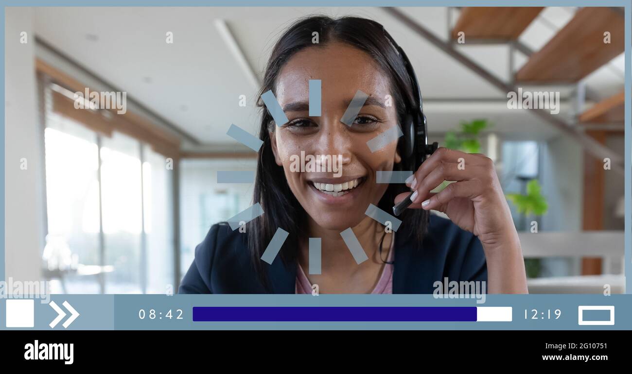 Composition of businesswoman talking on headset on video playback interface screen Stock Photo